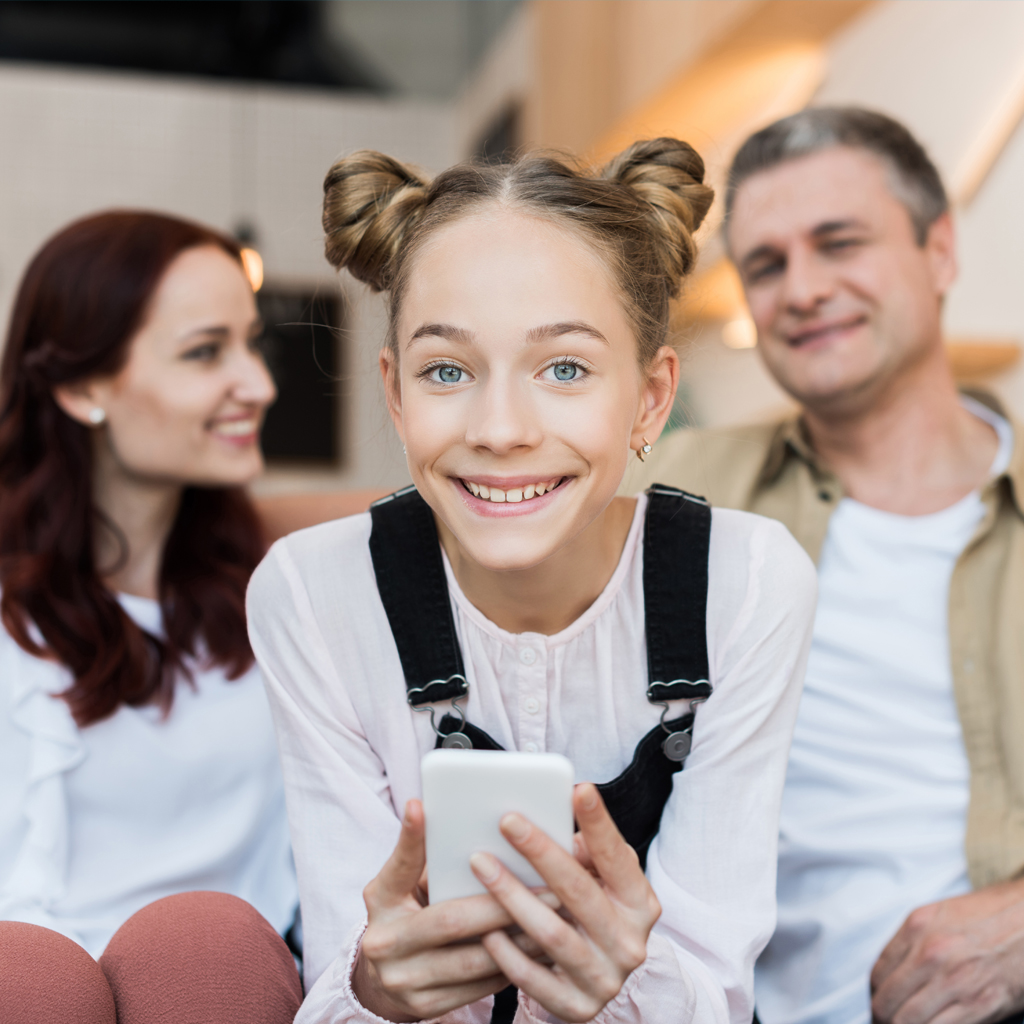 Girl Student Smiling while sitting with Parents